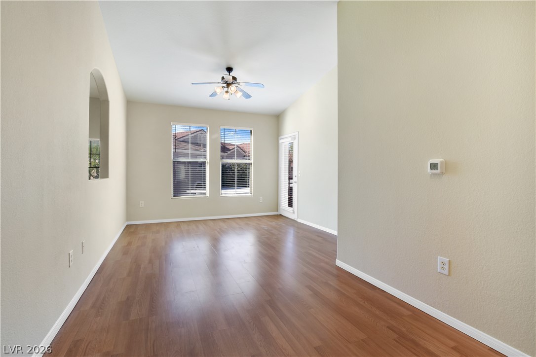10550 West Alexander Road, Unit 2171 Las Vegas, NV 89129 - Photo 2 of 17 Warm wood flooring flows through this airy room highlighted by vaulted ceilings and natural light.