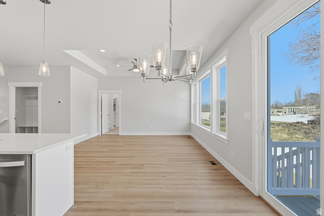 677 East 800 S Street Springville, UT 84663 - Photo 17 of 35 Unfurnished dining area with hanging lights, light wood-style floors, and a raised ceiling