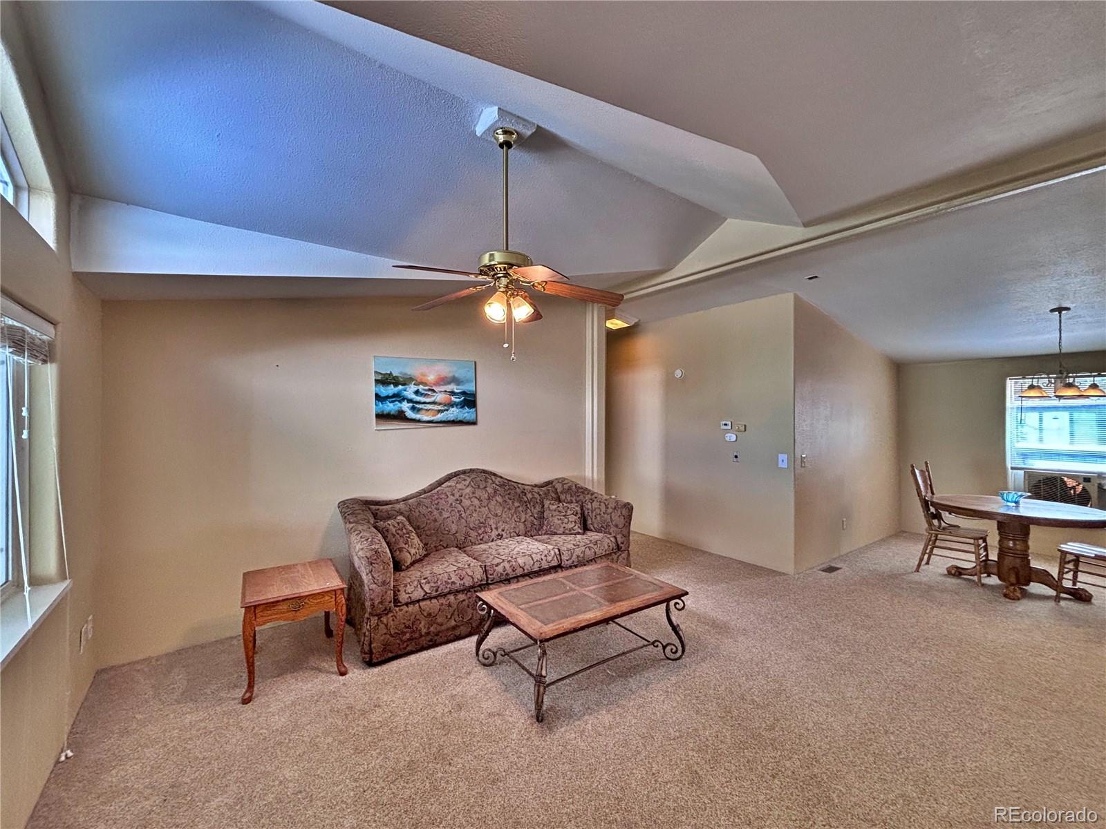 712 Meadowlark Drive Lafayette, CO 80026 - Photo 13 of 40 a living room with furniture and a ceiling fan