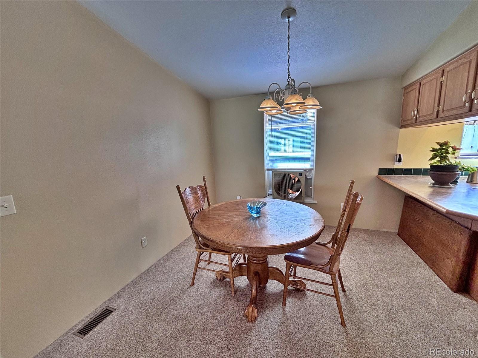 712 Meadowlark Drive Lafayette, CO 80026 - Photo 15 of 40 a view of a dining room with a table and chairs