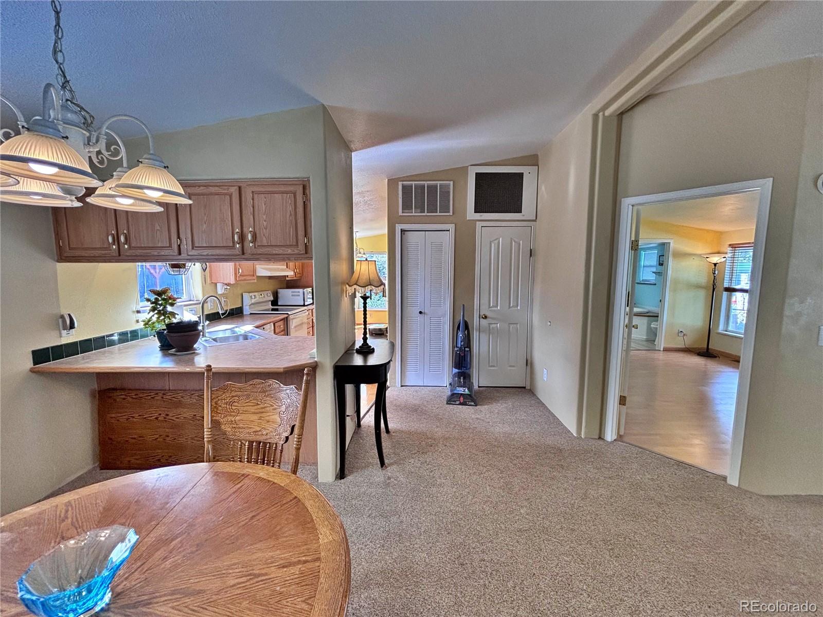 712 Meadowlark Drive Lafayette, CO 80026 - Photo 16 of 40 a view of a kitchen and dining room