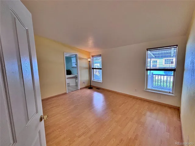 a view of an empty room and a window