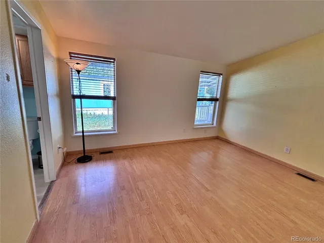 an empty room with windows and closet