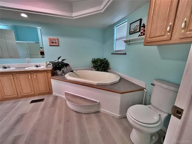 a white toilet sitting next to a bathroom sink and vanity