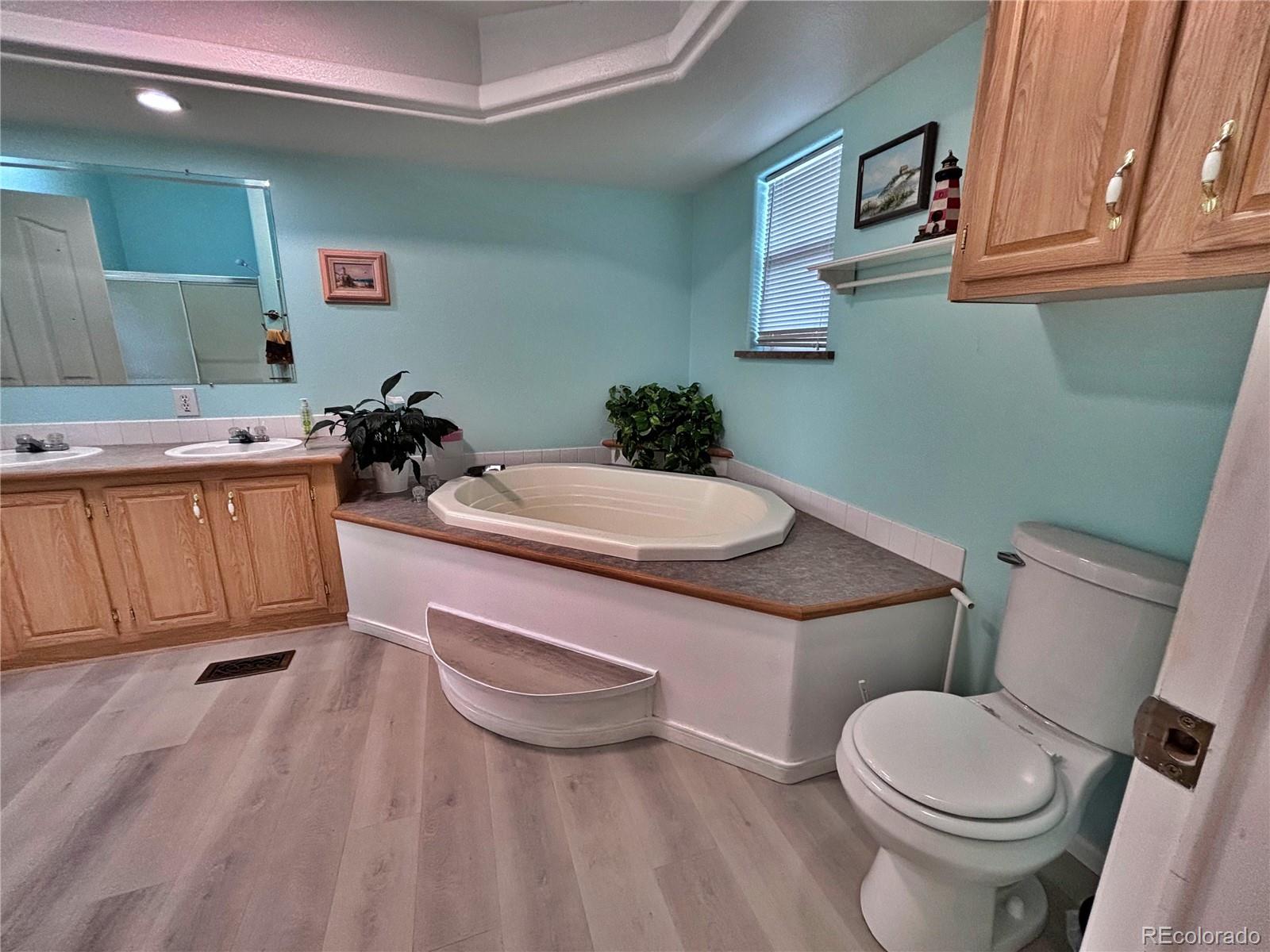 712 Meadowlark Drive Lafayette, CO 80026 - Photo 21 of 40 a white toilet sitting next to a bathroom sink and vanity