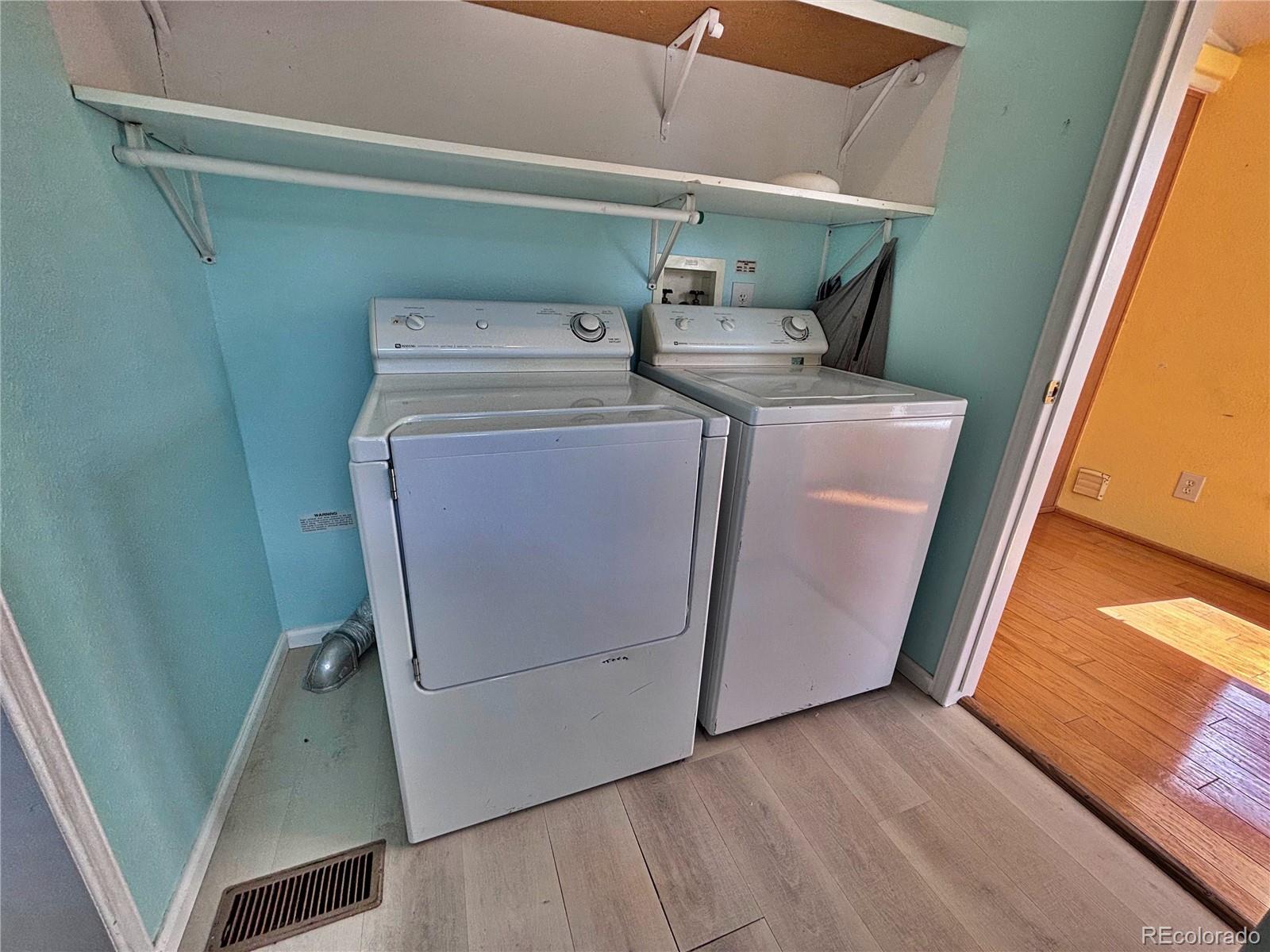 712 Meadowlark Drive Lafayette, CO 80026 - Photo 25 of 40 a utility room with dryer and washer
