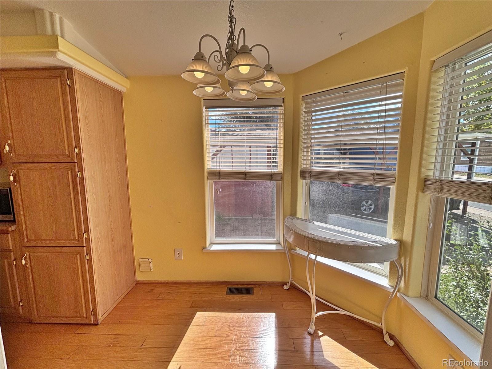 712 Meadowlark Drive Lafayette, CO 80026 - Photo 26 of 40 a view of an empty room with a window and wooden floor