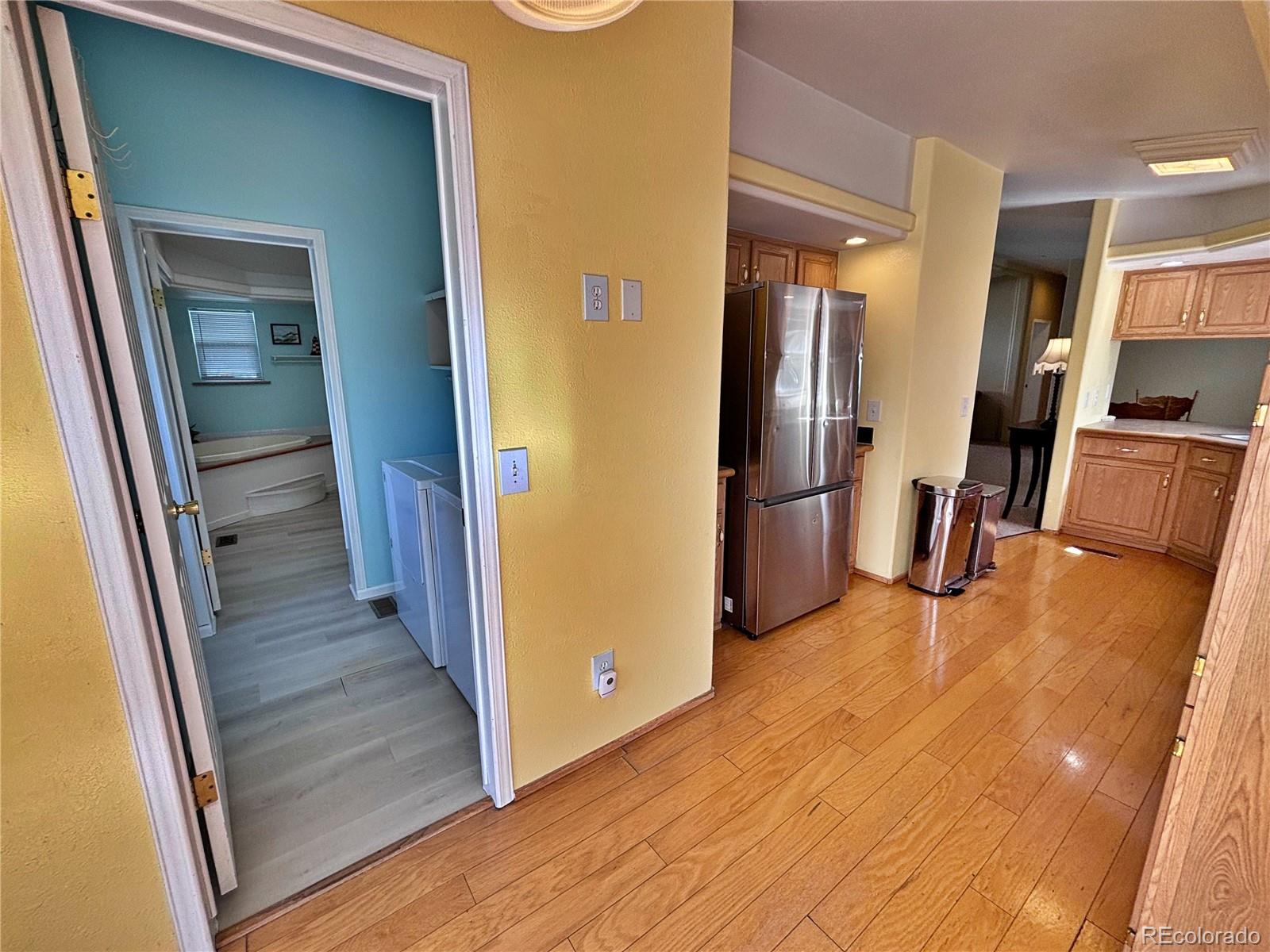 712 Meadowlark Drive Lafayette, CO 80026 - Photo 27 of 40 a view of a hallway with wooden floor and a living room