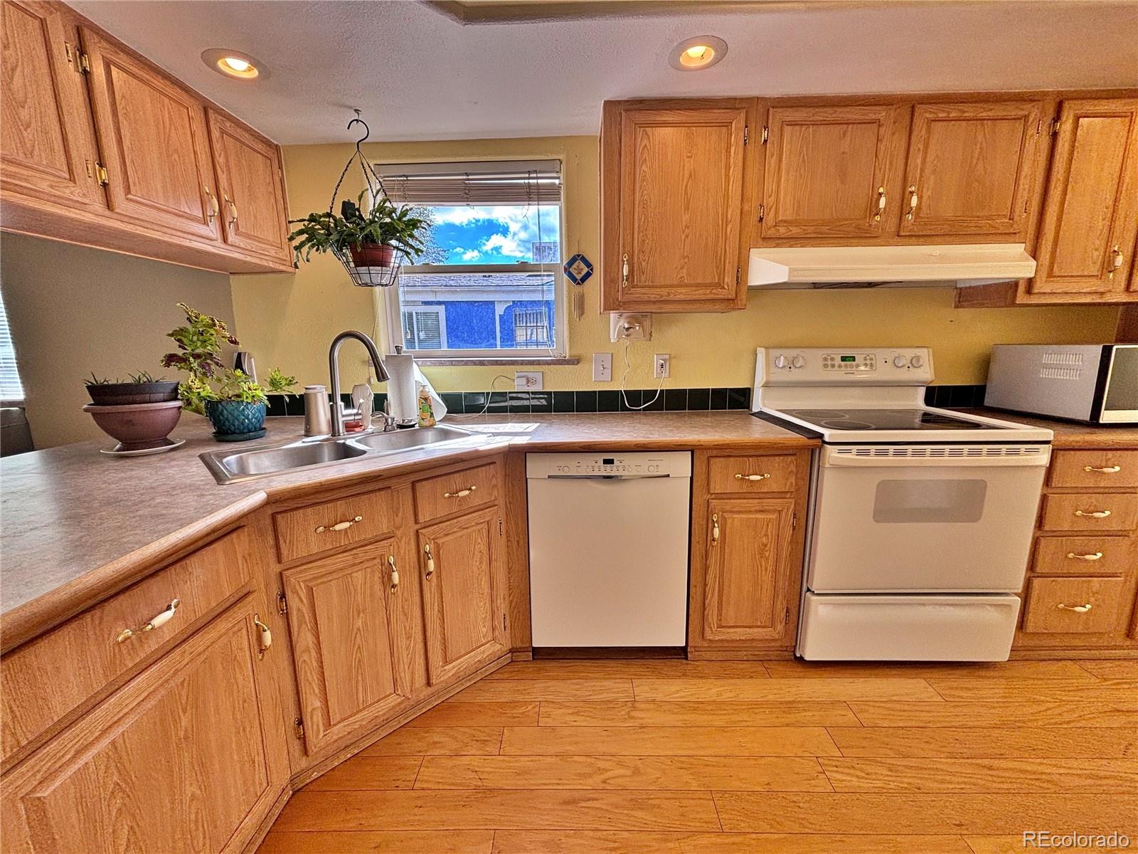 712 Meadowlark Drive Lafayette, CO 80026 - Photo 30 of 40 a kitchen with cabinets appliances a sink and a counter space