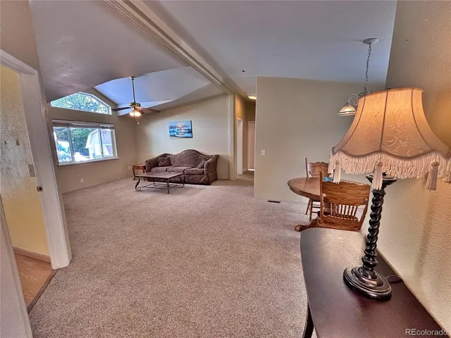 a living room with furniture and a lamp