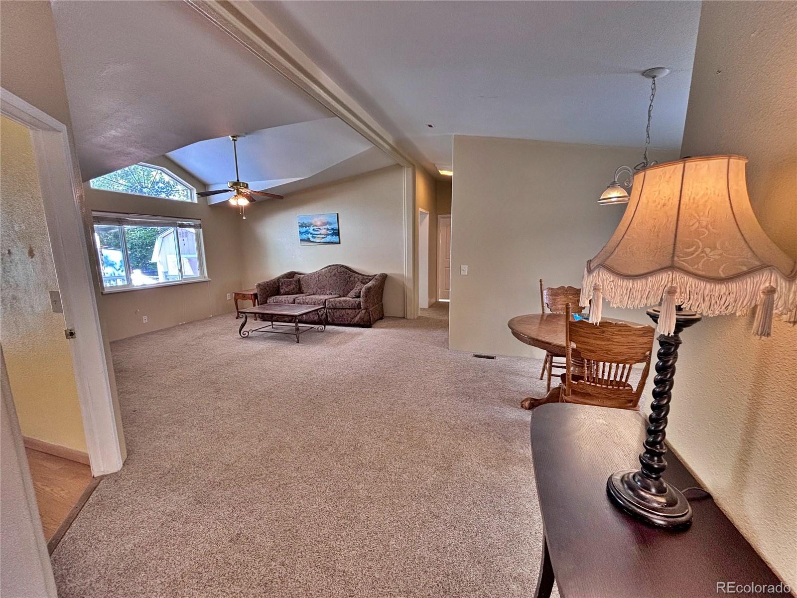 712 Meadowlark Drive Lafayette, CO 80026 - Photo 31 of 40 a living room with furniture and a lamp