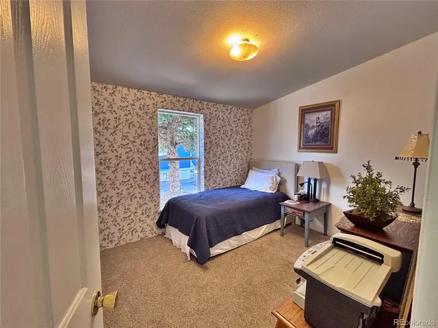 a bedroom with a bed and a potted plant