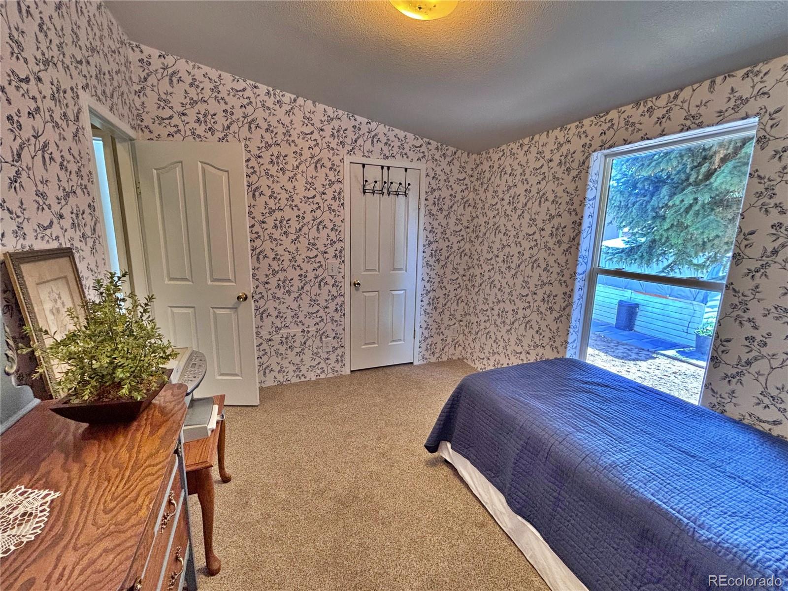 712 Meadowlark Drive Lafayette, CO 80026 - Photo 38 of 40 a bedroom with a bed and a fireplace