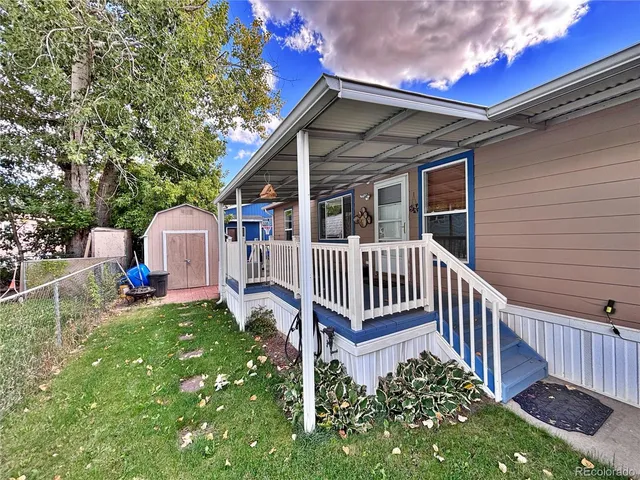 a view of a house with a yard and deck