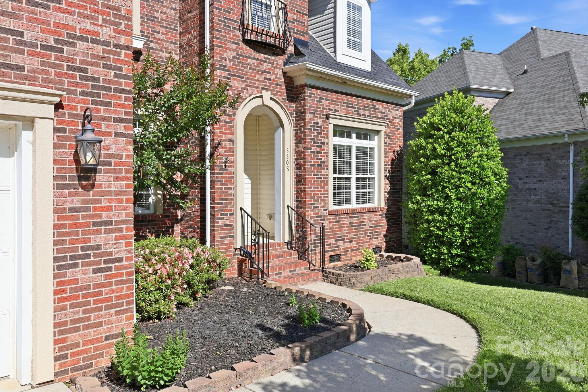 3308 Grandeur Road Charlotte, NC 28269 - Photo 2 of 45 a front view of a house with a garden