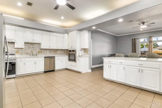 a kitchen with white cabinets a sink and white appliances