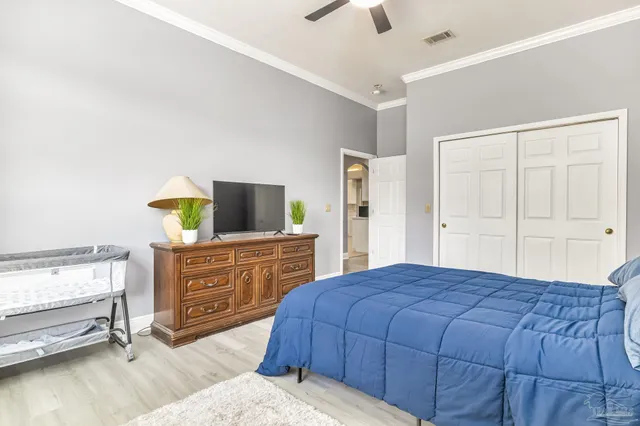 a bedroom with a bed and with furniture