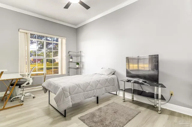 a bedroom with a bed a chair and a window