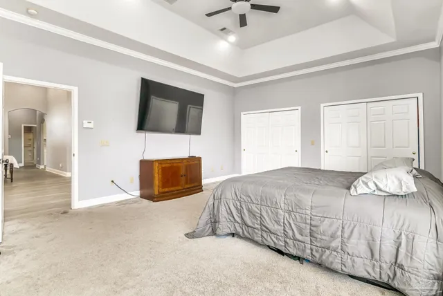 a bedroom with a bed and a television