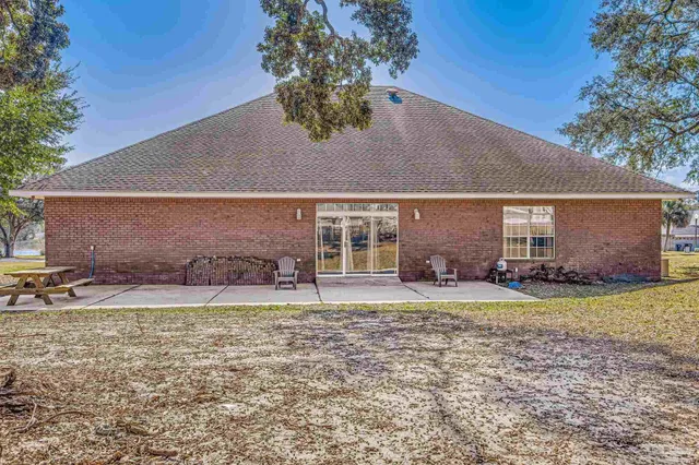 a front view of a house with a garden and patio