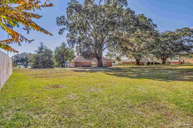 a house view with swimming pool in front of it