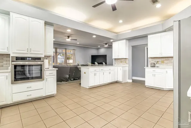 a kitchen with cabinets and white appliances