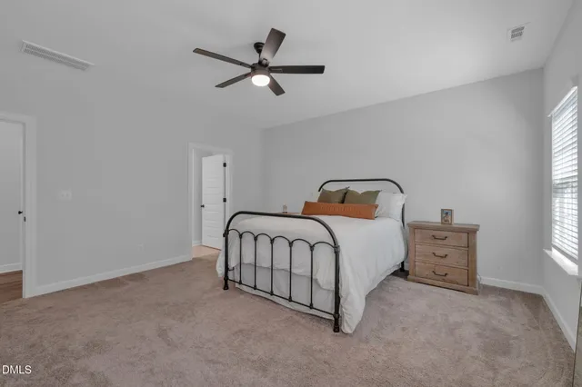 a bedroom with a bed and window