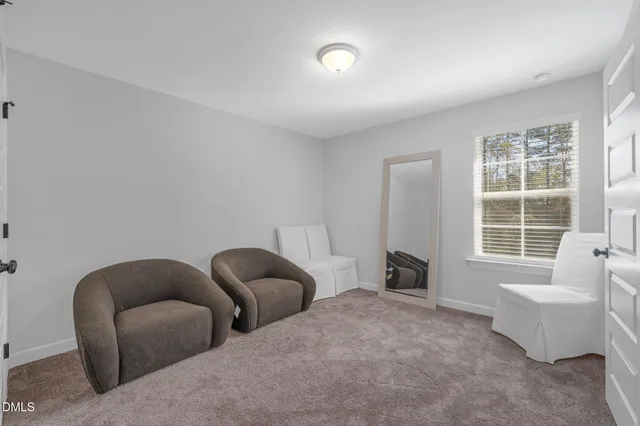 a livingroom with a couch and a bathroom