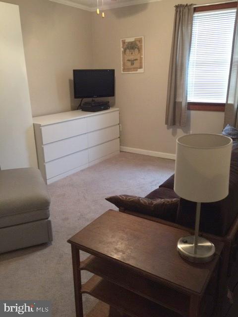 7925 Wynbrook Road Baltimore, MD 21224 - Photo 13 of 15 a living room with furniture and a flat screen tv