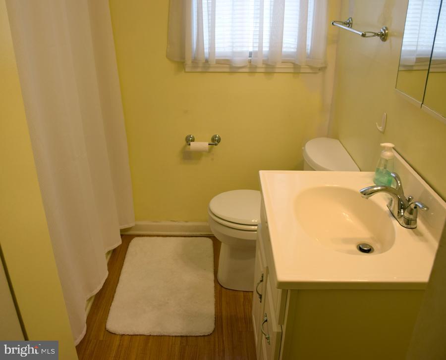 7925 Wynbrook Road Baltimore, MD 21224 - Photo 14 of 15 a bathroom with a sink and a toilet