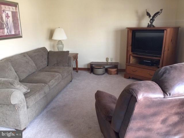 7925 Wynbrook Road Baltimore, MD 21224 - Photo 6 of 15 a living room with furniture and a flat screen tv