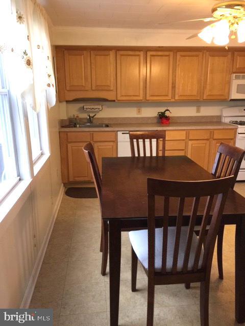7925 Wynbrook Road Baltimore, MD 21224 - Photo 8 of 15 a kitchen with a dining table chairs and window