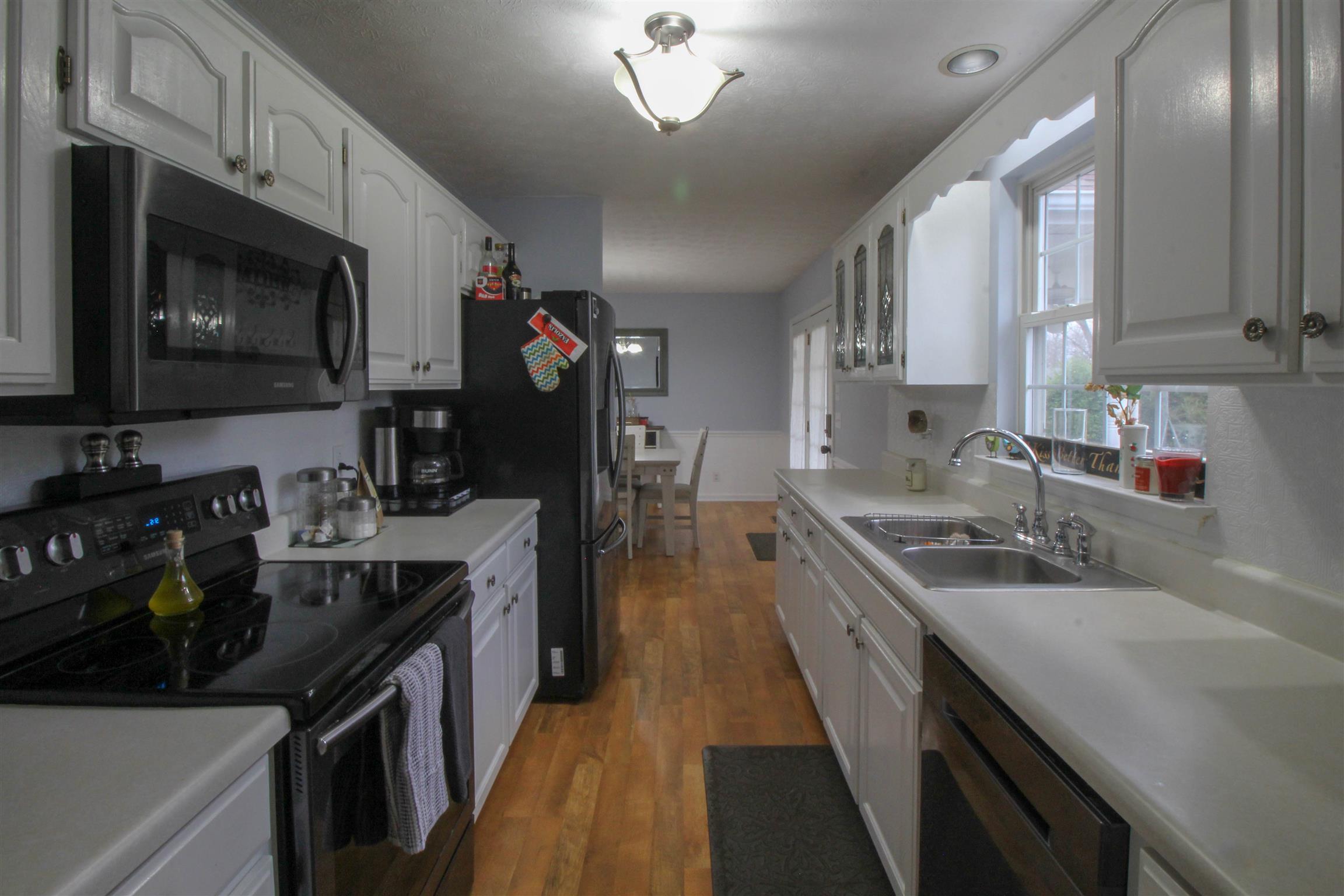 807 Hunters Crossing Lane Springfield, TN 37172 - Photo 11 of 16 a kitchen with a sink stove top oven and microwave