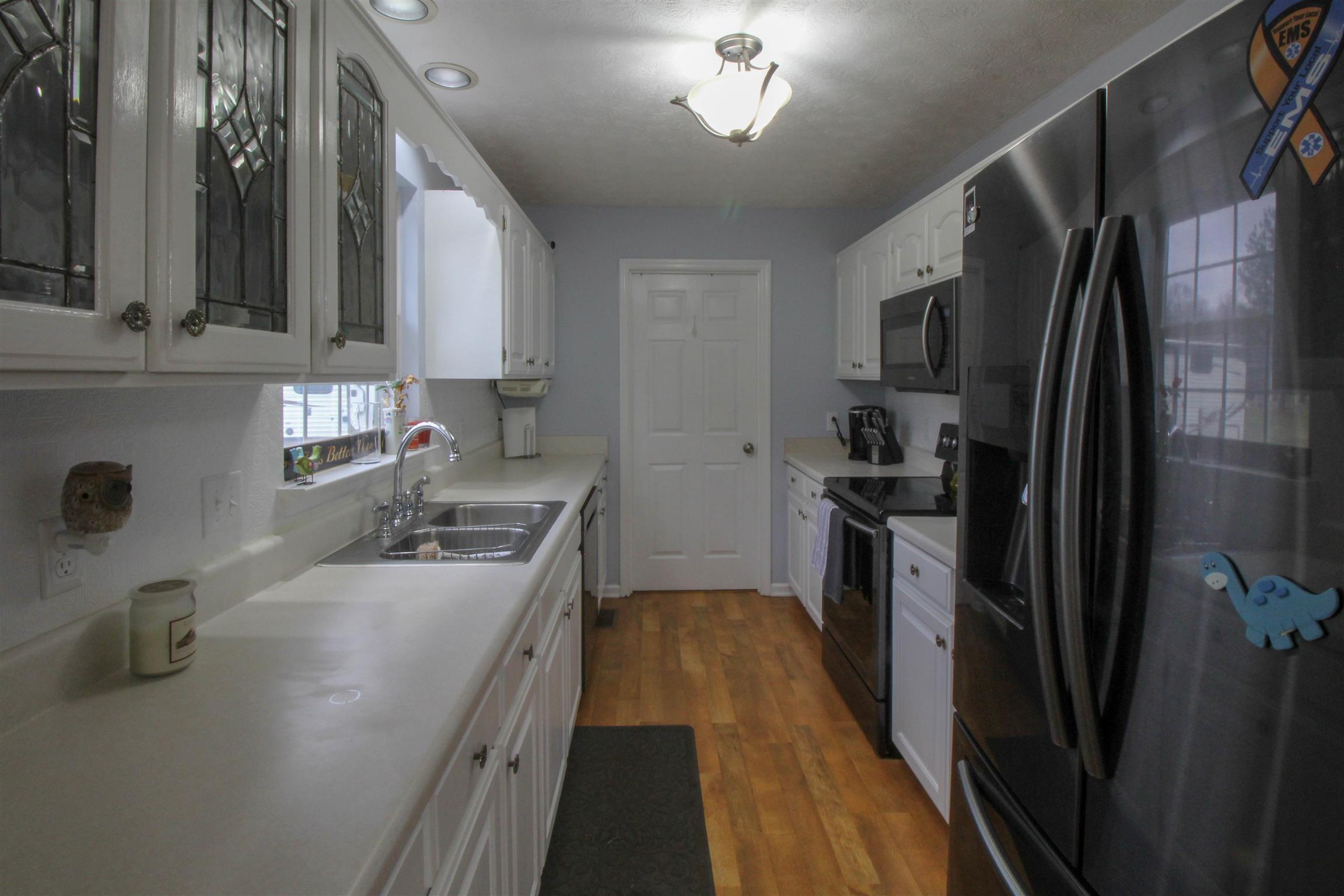 807 Hunters Crossing Lane Springfield, TN 37172 - Photo 12 of 16 a kitchen with kitchen island granite countertop stainless steel appliances a sink stove refrigerator and cabinets