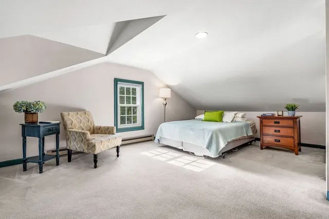 a bedroom with a bed and a chair