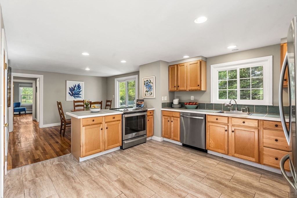 501 Farmers Row Groton, MA 01450 - Photo 3 of 19 a large kitchen with stainless steel appliances granite countertop a stove and a sink
