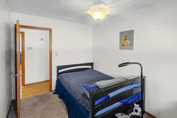 a bedroom with a bed and a chandelier