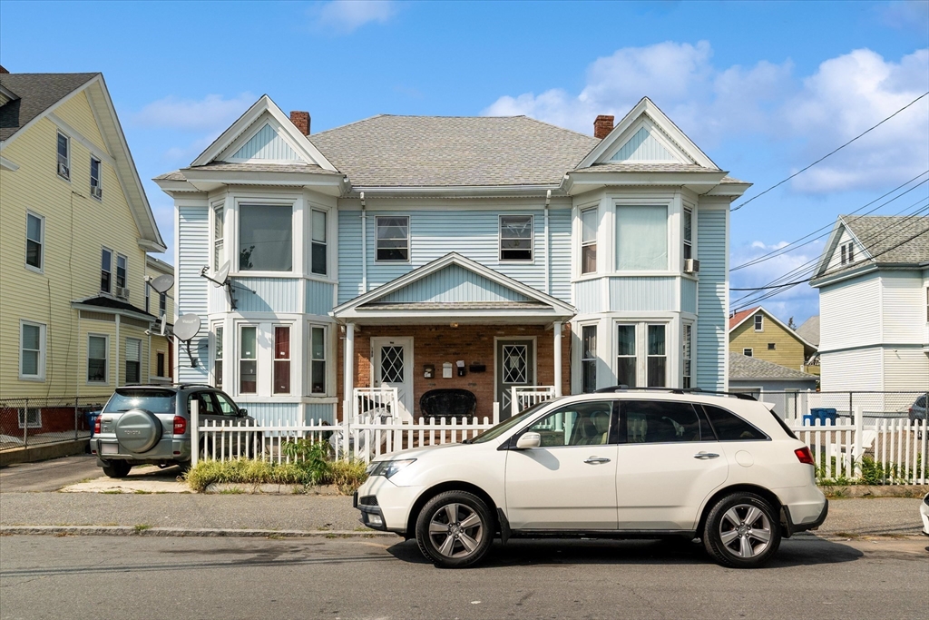 a view of a car parked in front of a residential houses