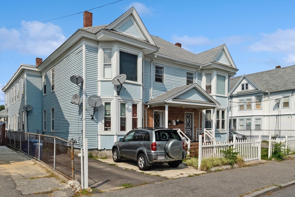 100 Bailey Street, Unit 3 Lawrence, MA 01843 - Photo 12 of 13 a front view of a house with parking area