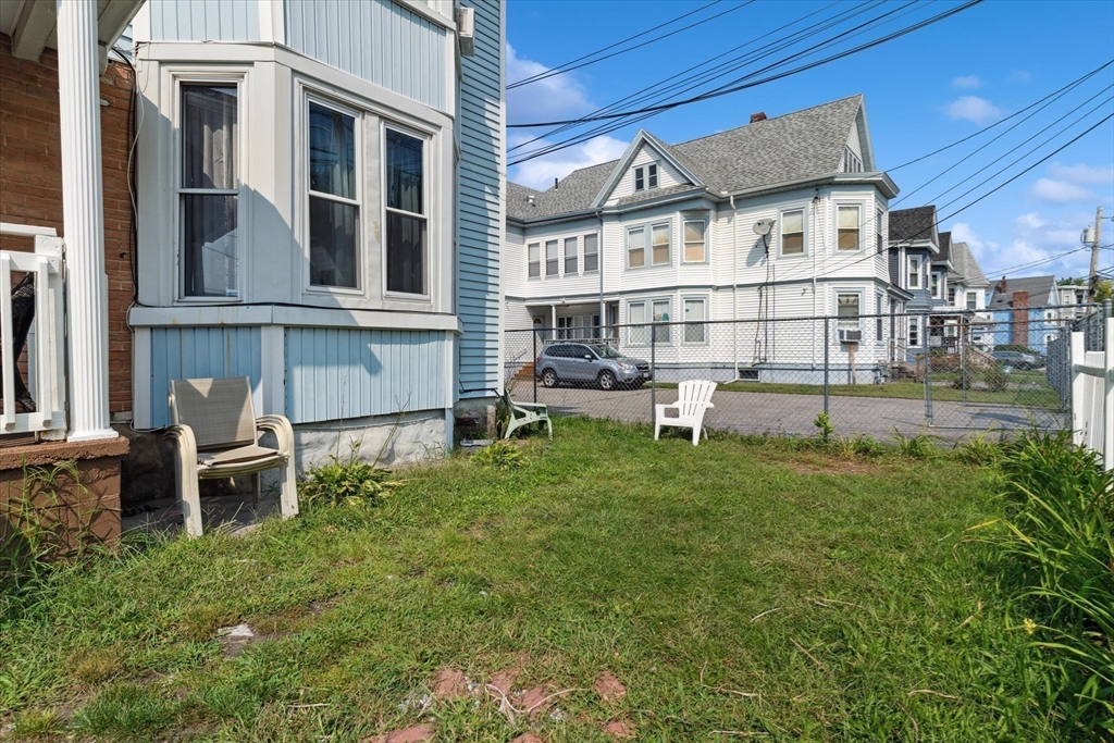 100 Bailey Street, Unit 3 Lawrence, MA 01843 - Photo 13 of 13 a backyard of a house with table and chairs