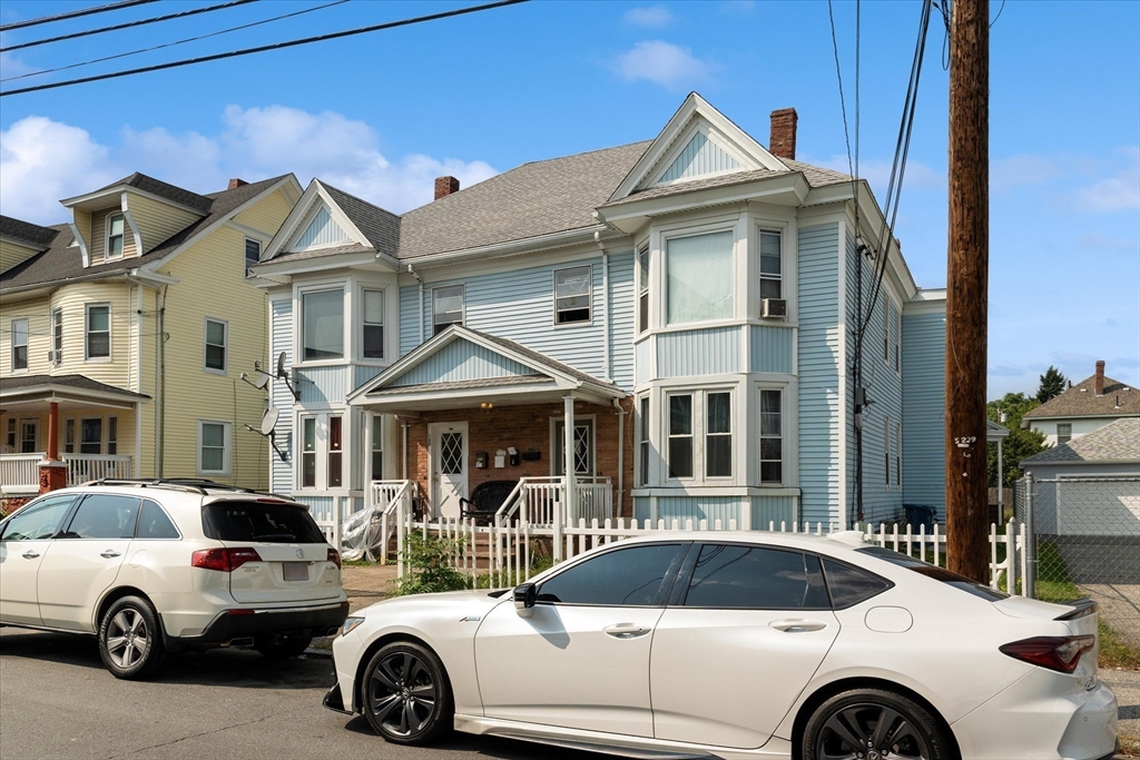 100 Bailey Street, Unit 3 Lawrence, MA 01843 - Photo 2 of 13 a view of a white house with a yard and balcony