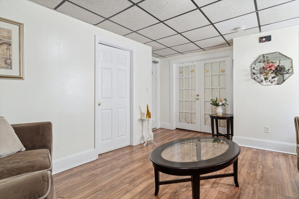 100 Bailey Street, Unit 3 Lawrence, MA 01843 - Photo 5 of 13 a living room with a couch and a table with wooden floor