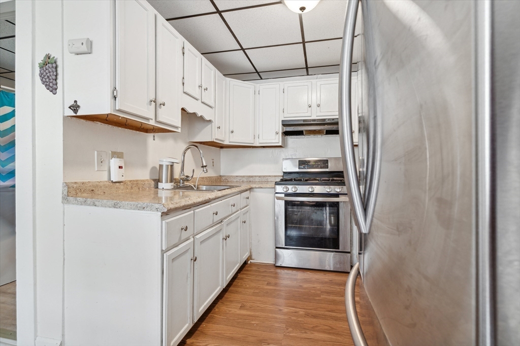 100 Bailey Street, Unit 3 Lawrence, MA 01843 - Photo 8 of 13 a kitchen with stainless steel appliances granite countertop a sink and cabinets
