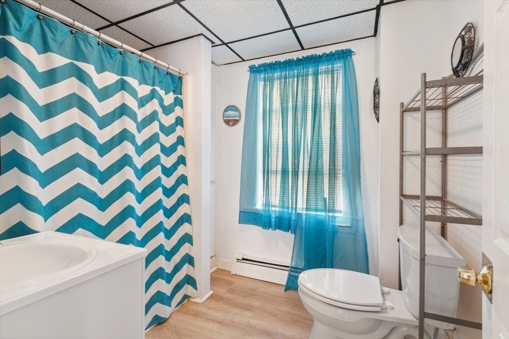 100 Bailey Street, Unit 3 Lawrence, MA 01843 - Photo 9 of 13 a bathroom with a sink toilet and shower