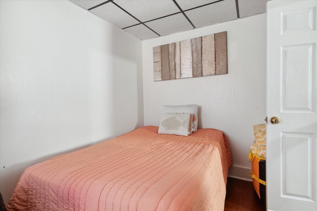 100 Bailey Street, Unit 3 Lawrence, MA 01843 - Photo 10 of 13 a bedroom with a bed and a table