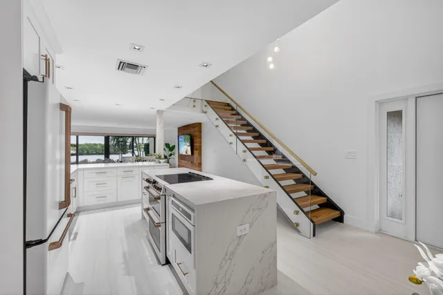 a living room with furniture potted plant and a large window
