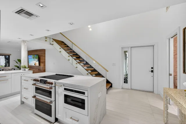 a living room with furniture and a floor to ceiling window