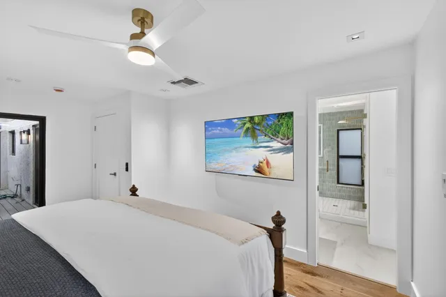 a bedroom with a large bed and a chandelier