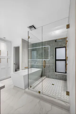 a bathroom with a granite countertop sink toilet a mirror and shower