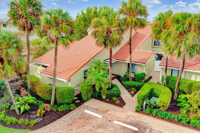 a view of a house with potted plants